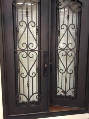 Double wrought iron door EL1125 MCD with geometric scrollwork and rosettes, hand-forged for durability and artistry.