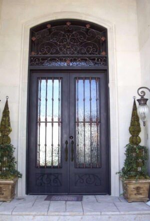 Double wrought iron door EL1111 MCD with scrollwork and decorative transom, hand-forged for strength and luxury appeal.