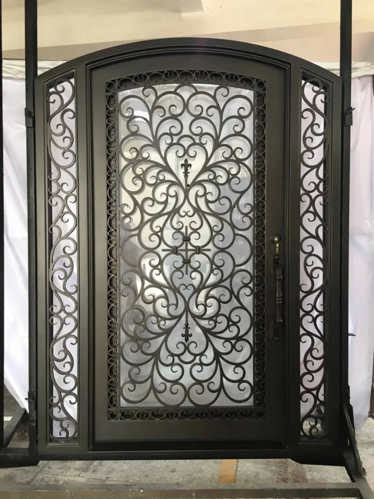Wrought iron door EL1165 MCD with scrollwork and side transoms, hand-forged for architectural luxury and strength.