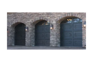 arch top wrought iron garage door GD4006 MCDwith decorative iron accents and glass inserts by Monarch Custom Doors