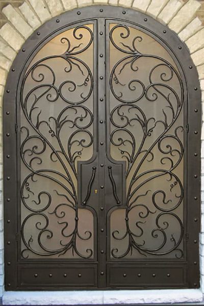 EL5000 MCD arched double wrought iron door with flowing scroll grille and insulated glass panels